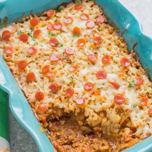 An awesome twist on a classic, this Pizza Shepherd's Pie combines sausage, pepperoni, cheese and hash brown potatoes to give you a hearty casserole worth devouring. | Strawberry Blondie Kitchen