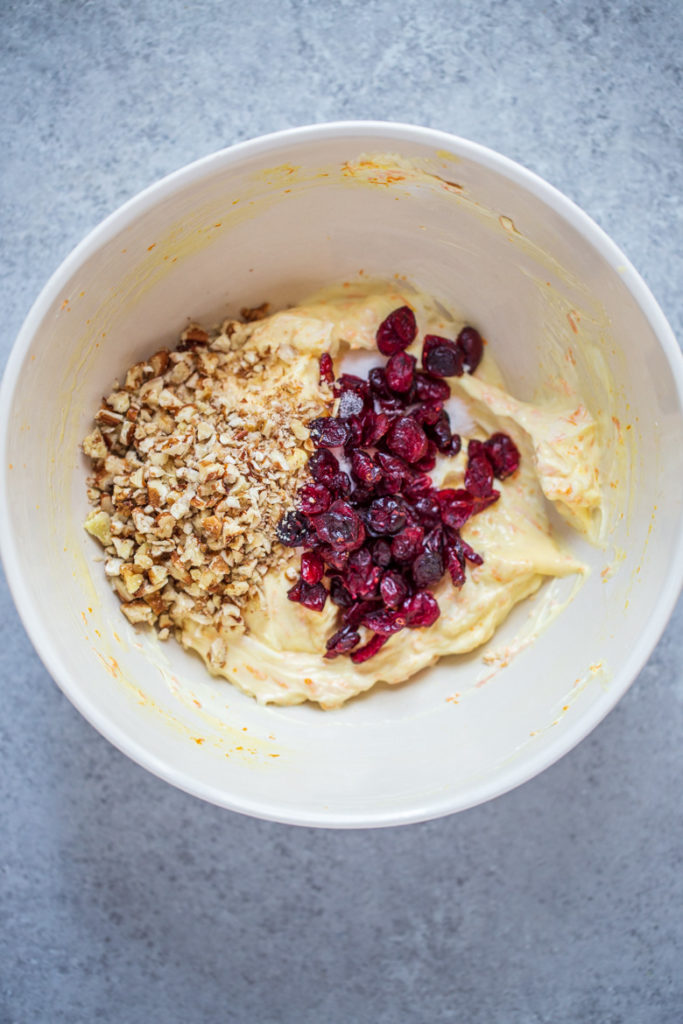 Transfer to a bowl and fold in ¼ cup cranberries and ¼ cup pecans. 