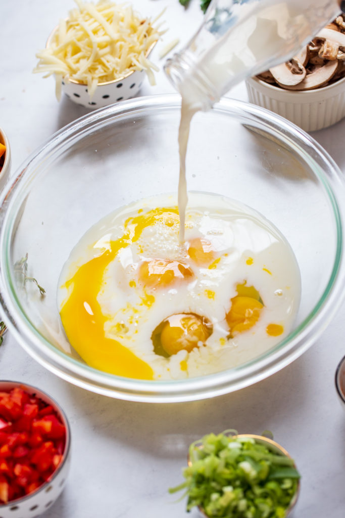 Into a large bowl add eggs, milk, salt, pepper, paprika, cayenne, cheeses and leeks to make easy vegetable quiche