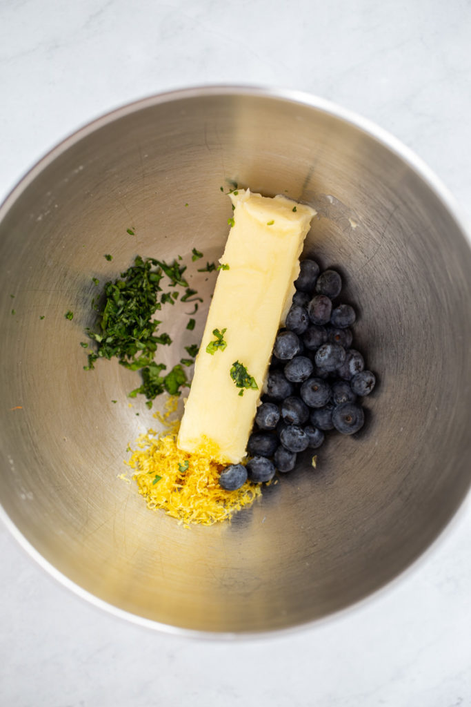 Ingredients in a mixing bowl for blueberry lemon basil butter
