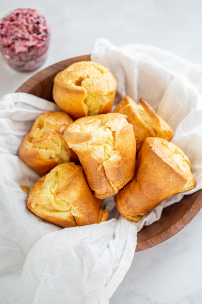 Popovers in a bowl with blueberry basil butter