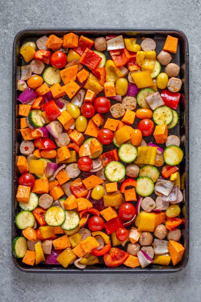 Place chopped vegetables and sauages evenly onto sheet pan