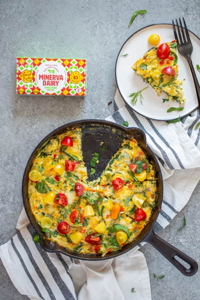 Overhead view of Garden Herb Frittata with a slice cut out placed on a plate.