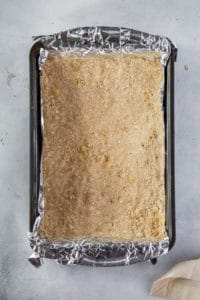 flour oat mixture crust pressed into the bottom of a 13 x 9 inch pan