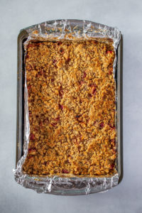Fully baked pan of peach cobbler crumble bars