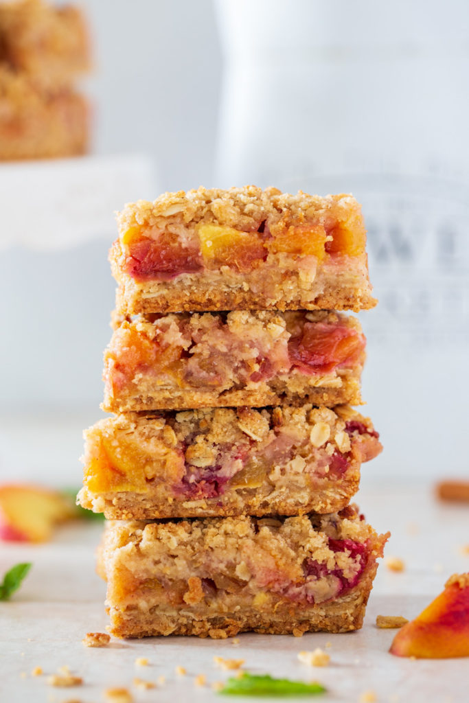 Close up shot of 4 stack peach cobbler oatmeal bars