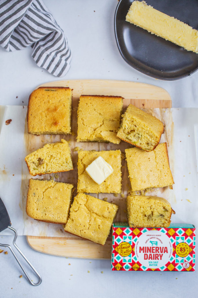 cornbread on a cutting board cut into pieces