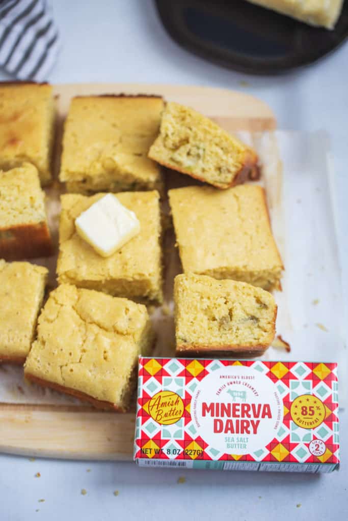 cornbread sliced on a cutting board with Minerva Dairy butter