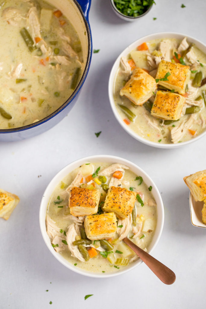 Bowls full of chicken pot pie soup with puff pastry croutons