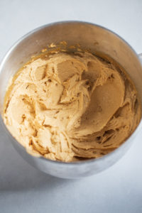 Cookie dough in bowl of stand mixer.